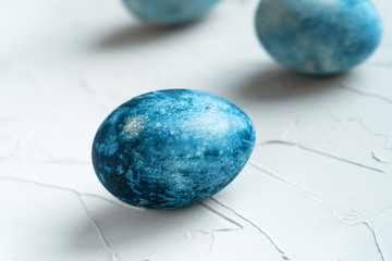 Painted blue eggs for easter holiday. Three painted eggs on the table. Holy Easter with natural paints.