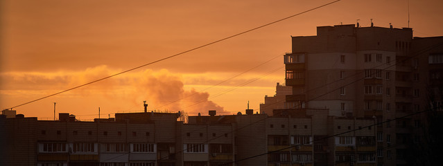 morning orange sky over a depressing cityscape