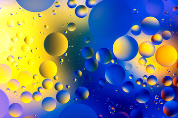 photo, bright oily drops in water with colorful background, close-up 