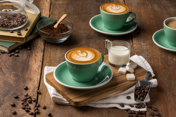 Hot coffee decorated with chocolate, sugar and coffee beans. 