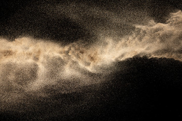 Fototapeta na wymiar Brown dry river sand explosion isolated on black background. Abstract sand splash.
