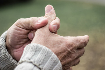 Elderly man has pain in fingers and hands  - obrazy, fototapety, plakaty