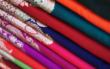 Closeup view of stacked saris or sarees in display of retail shop                                - obrazy, fototapety, plakaty