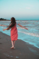 Girl dancing on the seashore.
