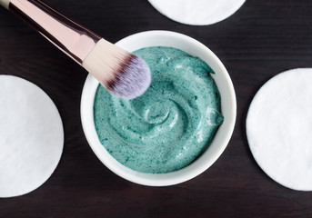 Green (blue) bentonite clay and yogurt mask in the bowl. Diy facial mask and body wrap recipe....
