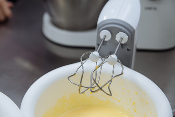 motion blurred dough beating with electric mixer close up