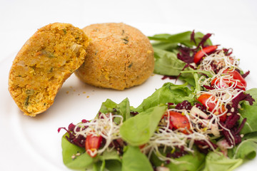 Plant-based food on white plate.