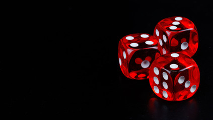 Red dice in dark black background