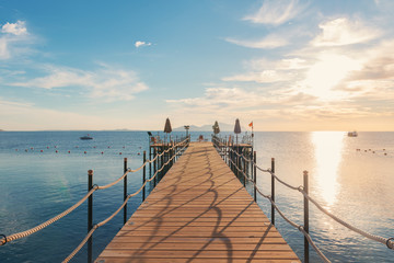 Pier on the background of the sea and the sunny sky