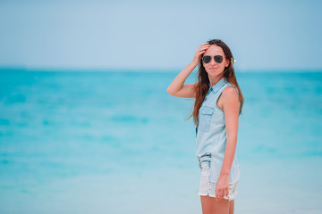 Young fashion woman in green dress on the beach