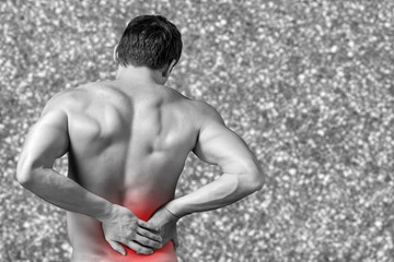 Obraz premium A man holds his back with awful pain