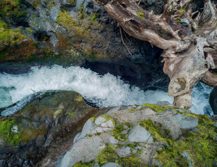 Dazzling Deschutes Falls plunging over the cliff into a breathtaking canyon surrounded by green bushes in Thurston County Yelm Washington State