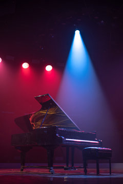 The Piano On Stage In The Spotlight.