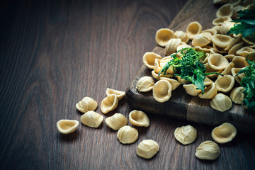 Obraz na płótnie Canvas Fresh Italian pasta Orecchiette with turnip leaves and tops. Recipes of southern Italy, Puglia