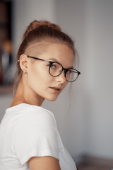 Portrait of a cute blonde wearing glasses