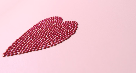 Big red love heart shiny puzzle round crystal circles shape concept on pink background. Flat lay side view, copy space valentines day.