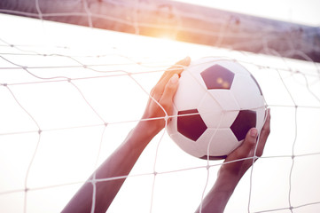 The cropped image of sports players who catch the ball and the football field. Sports-image concept.