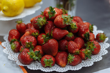 red fresh strawberries lying on the plate