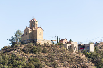 Fototapeta premium View from the Narikhala Hill to the Tabor Monastery of the Transfiguration in old part of Tbilisi city in Georgia