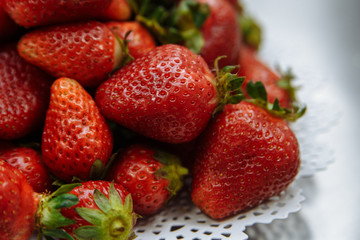 red fresh strawberries lying on the plate
