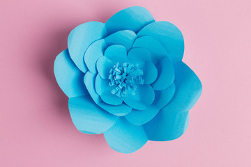 pink background with blue flower of paper