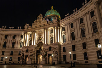 Fototapeta na wymiar Vienna, Austria. Hofburg Palace main entrance seen from Michaelerplatz at night, wide-angle view at dusk, Habsburg Empire landmark in Vienna