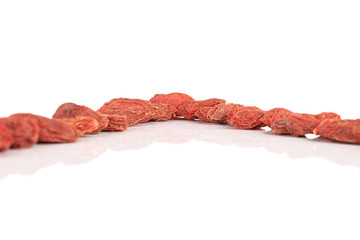 Lot of whole dried red goji isolated on white background