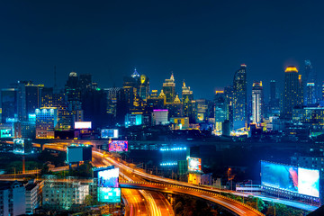 Fototapeta na wymiar Soi Rangnam, Bangkok Buildings in the heart of the capital city that shine beautifully at night.
