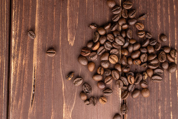 Lot of whole fresh coffee bean flatlay on brown wood