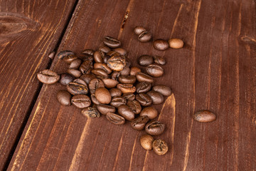 Lot of whole fresh coffee bean on brown wood