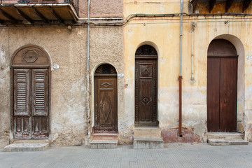 picturesque doors, narrow and low, of houses in Sicily