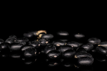 Lot of whole black bean heap isolated on black glass