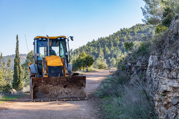 A Backhoe Loader Clearing a Path