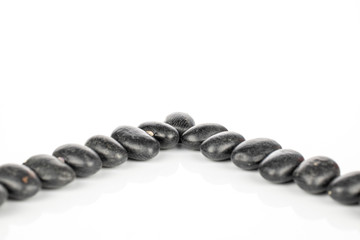 Lot of whole black bean isolated on white background