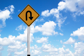 road sign with blue sky and clouds