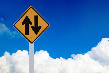 road sign with blue sky and clouds