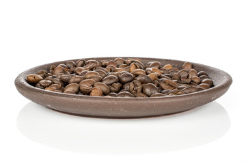 Lot of whole fresh coffee bean with brown ceramic coaster isolated on white background