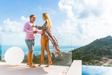 A beautiful couple spends a honeymoon in a luxurious villa with a pool and sea views. Exotic and Romance for Man and Woman in Thailand. Koh Samui