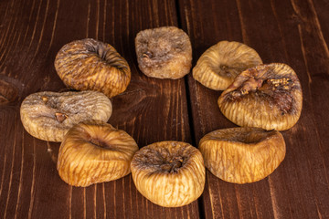 Group of eight whole dried fig on brown wood