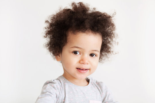 Cute funny little girl with curly hair
