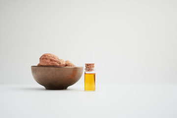 Walnuts and walnut oil on a white background