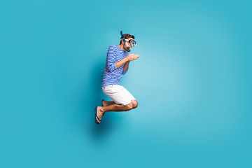 Full size profile photo of funky crazy guy tourist jump high swimming deep water mask tube diving wear striped sailor shirt vest shorts flip flops isolated blue color background - Powered by Adobe