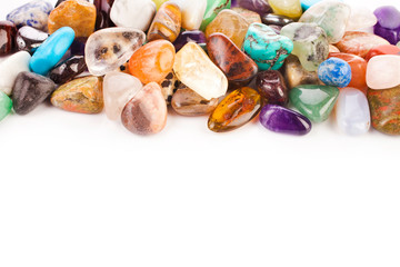 Colorful semiprecious gemstones isolated on a white background.