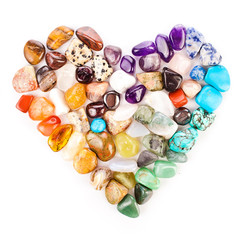 Obraz na płótnie Canvas Heart made of colorful semiprecious gemstones isolated on a white background.