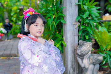 asian little girl Wearing yukata in graden