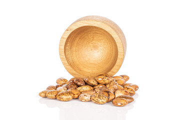 Lot of whole mottled brown bean pinto in bamboo bowl isolated on white background