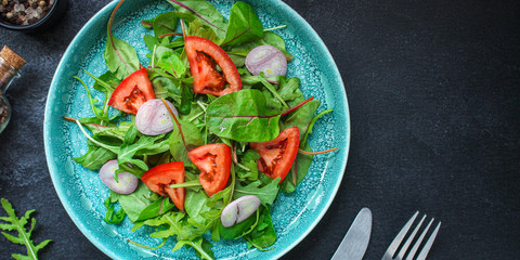 Healthy salad, leaves mix salad (mix micro greens, cucumber, tomato, onion, other ingredients). food background. copy space