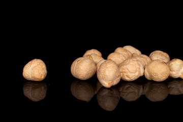 Lot of whole fresh tan chickpea isolated on black glass