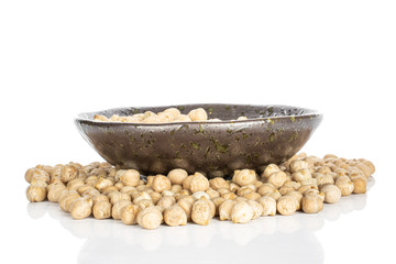 Lot of whole raw fresh tan chickpea in glazed bowl isolated on white background