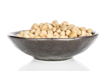Lot of whole fresh tan chickpea in glazed bowl isolated on white background